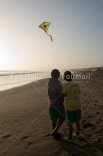 Fair Trade Photo Activity, Backlit, Beach, Clouds, Colour image, Evening, Freedom, Friendship, Hope, Kite, Outdoor, People, Peru, Playing, Sea, Silhouette, Sky, South America, Summer, Sunset, Together, Two boys, Water