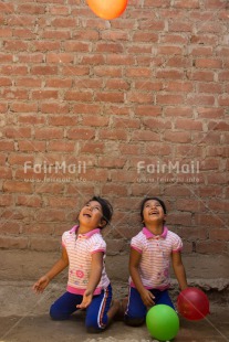 Fair Trade Photo Activity, Balloon, Colour image, Emotions, Friendship, Happiness, Party, People, Peru, Playing, Smiling, South America, Together, Twin, Two girls, Vertical