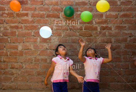 Fair Trade Photo Activity, Balloon, Colour image, Emotions, Friendship, Happiness, Horizontal, Party, People, Peru, Playing, Smiling, South America, Together, Twin, Two girls