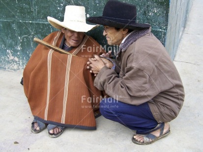 Fair Trade Photo Activity, Clothing, Colour image, Communication, Dailylife, Day, Friendship, Hat, Horizontal, Latin, Looking away, Outdoor, People, Peru, Poncho, Portrait fullbody, Sitting, South America, Streetlife, Talking, Together, Traditional clothing, Two men