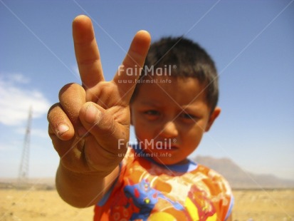Fair Trade Photo 5 -10 years, Activity, Casual clothing, Clothing, Colour image, Communication, Focus on foreground, Horizontal, Latin, Looking at camera, One boy, Peace, People, Peru, Portrait halfbody, Seasons, Sky, South America, Summer