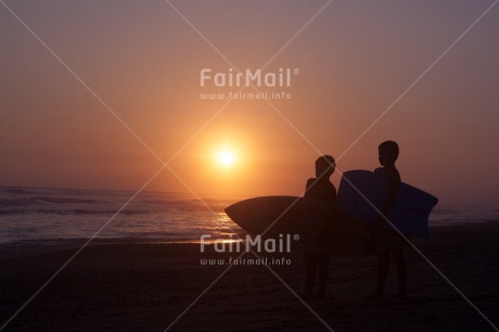 Fair Trade Photo Beach, Colour image, Emotions, Evening, Friendship, Happiness, Horizontal, Outdoor, People, Peru, Sea, South America, Sport, Sunset, Surfboard, Two boys