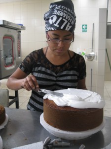 Patricia finishing off a birthday cake