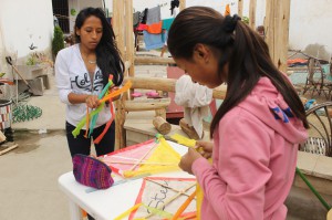 Anidela and Ruth making kites from trash