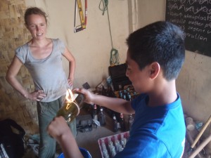 FairMail Peru teenager Dante helping Janneke to cut  some bottles