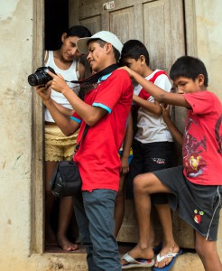 Juan Gabtiel showing his pictures to the local youth