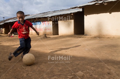 Fair Trade Photo 5 -10 years, Activity, Casual clothing, Clothing, Colour image, Dailylife, Day, Latin, One boy, Outdoor, People, Peru, Playing, Portrait fullbody, Rural, Smiling, Soccer, South America, Streetlife