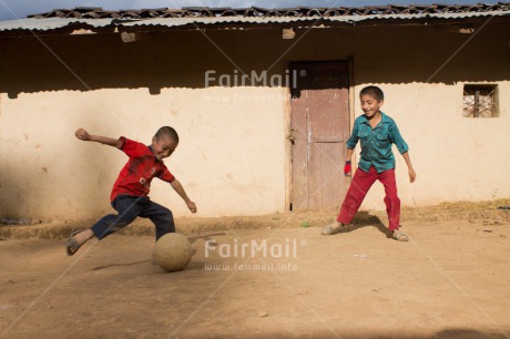 Fair Trade Photo 5 -10 years, Activity, Casual clothing, Clothing, Colour image, Dailylife, Day, Friendship, Latin, Outdoor, People, Peru, Playing, Portrait fullbody, Rural, Smiling, Soccer, South America, Streetlife, Together, Two boys