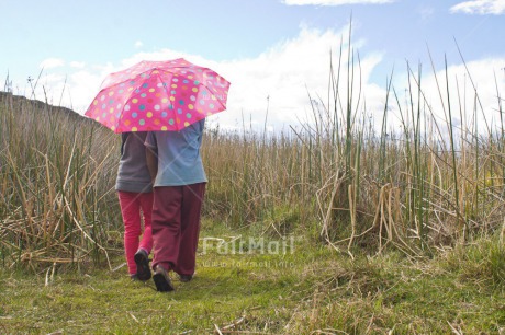 Fair Trade Photo Activity, Colour image, Day, Friendship, Horizontal, Outdoor, People, Peru, Rural, South America, Together, Two girls, Umbrella, Walking