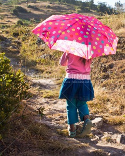 Fair Trade Photo 5 -10 years, Activity, Colour image, Emotions, Happiness, Latin, One girl, People, Peru, Pink, South America, Travel, Umbrella, Vertical, Walking