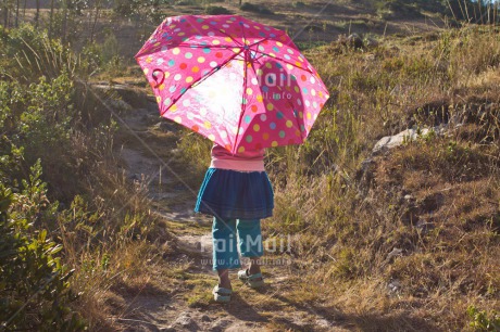 Fair Trade Photo 5 -10 years, Activity, Colour image, Emotions, Happiness, Horizontal, Latin, One girl, People, Peru, Pink, South America, Travel, Umbrella, Walking