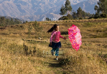 Fair Trade Photo 5 -10 years, Activity, Colour image, Emotions, Happiness, Horizontal, Latin, One girl, People, Peru, Pink, South America, Travel, Umbrella, Walking