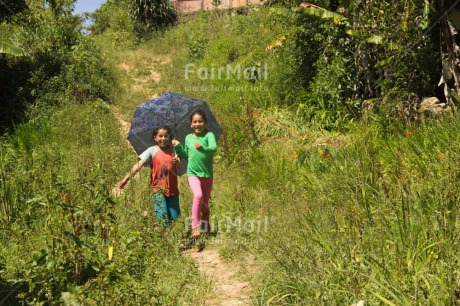 Fair Trade Photo Activity, Casual clothing, Clothing, Colour image, Day, Emotions, Friendship, Happiness, Horizontal, Outdoor, People, Peru, Running, Rural, Smiling, South America, Together, Two girls, Umbrella, Walking