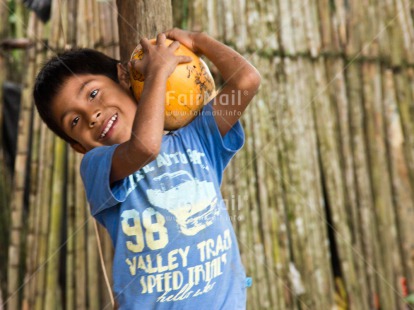 Fair Trade Photo Activity, Agriculture, Carrying, Coconut, Colour image, Fair trade, Horizontal, Looking at camera, One boy, People, Rural, Smiling