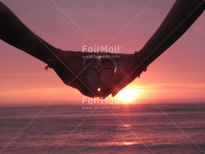 Fair Trade Photo Baby, Colour image, Couple, Hands, Holding, Horizontal, Love, New baby, Ocean, Outdoor, People, Peru, Sea, Shoe, South America, Sunset, Two