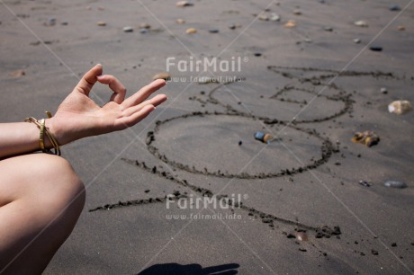 Fair Trade Photo Beach, Closeup, Colour image, Hand, Horizontal, Letter, One girl, Outdoor, People, Peru, Sand, South America, Stone, Yoga