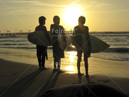 Fair Trade Photo 15-20 years, Beach, Colour image, Evening, Friendship, Group of boys, Group of children, Horizontal, Outdoor, People, Peru, Sand, Sea, South America, Sport, Sunset, Surfboard