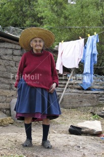 Fair Trade Photo 75-80 years, Activity, Clothing, Colour image, Day, Hat, Latin, Looking away, Old age, One woman, Outdoor, People, Peru, Portrait fullbody, Rural, Sombrero, South America, Standing, Traditional clothing, Vertical