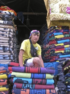Fair Trade Photo 15-20 years, Activity, Blanket, Colour image, Day, Entrepreneurship, Latin, Looking at camera, Market, One boy, Outdoor, People, Peru, Portrait fullbody, Selling, Sitting, South America, Vertical