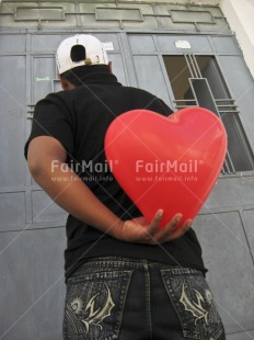 Fair Trade Photo 15-20 years, Activity, Casual clothing, Clothing, Colour image, Day, Door, Giving, Heart, House, Love, One boy, Outdoor, People, Peru, Red, South America, Street, Surprise, Valentines day, Vertical