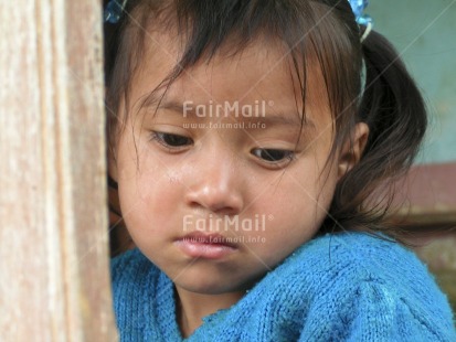 Fair Trade Photo 5-10 years, Activity, Blue, Casual clothing, Clothing, Colour image, Day, Emotions, Horizontal, Latin, Looking away, One girl, Outdoor, People, Peru, Portrait headshot, Sadness, Sorry, South America, Thinking of you