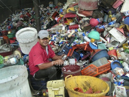 Fair Trade Photo Activity, Child labour, Colour image, Day, Family, Garbage, Garbage belt, Health, Horizontal, Hygiene, Looking at camera, Multi-coloured, One man, Outdoor, People, Peru, Portrait fullbody, Recycle, Safety, Sanitation, Sitting, Smiling, South America, Working