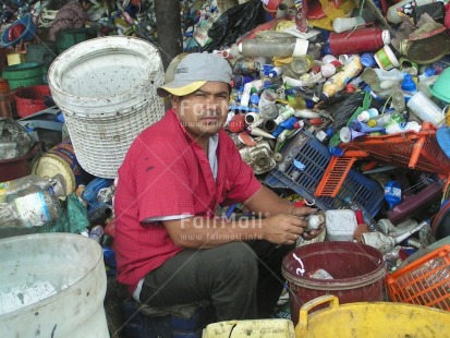 Fair Trade Photo Activity, Child labour, Colour image, Day, Family, Garbage, Garbage belt, Health, Horizontal, Hygiene, Looking at camera, Multi-coloured, One man, Outdoor, People, Peru, Portrait fullbody, Recycle, Safety, Sanitation, Sitting, South America, Working