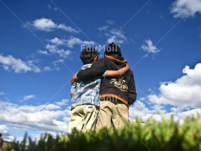 Fair Trade Photo 5 -10 years, Activity, Care, Casual clothing, Clothing, Colour image, Cooperation, Day, Emotions, Friendship, Happiness, Horizontal, Hugging, Latin, Looking away, Low angle view, Outdoor, People, Peru, Portrait halfbody, Rural, Smiling, South America, Together, Two boys, Two children