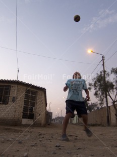 Fair Trade Photo Activity, Ball, Dailylife, Evening, Jumping, Light, One boy, Outdoor, People, Peru, Playing, South America, Streetlife, Vertical
