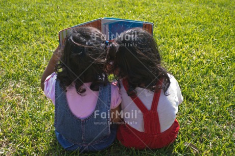 Fair Trade Photo 0-5 years, Book, Casual clothing, Clothing, Colour image, Cooperation, Cute, Day, Education, Friendship, Grass, Latin, Outdoor, People, Peru, Reading, School, Sister, South America, Together, Two girls