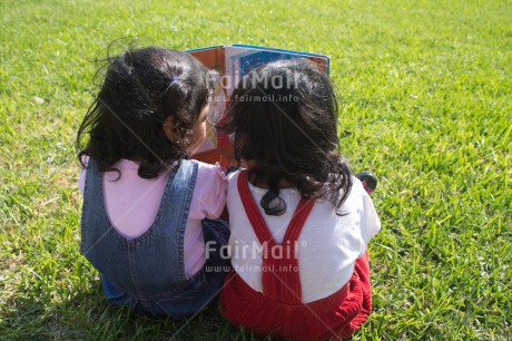 Fair Trade Photo 0-5 years, Book, Casual clothing, Clothing, Colour image, Cooperation, Cute, Day, Education, Friendship, Grass, Latin, Outdoor, People, Peru, Reading, School, Sister, South America, Together, Two girls