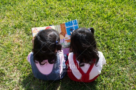 Fair Trade Photo 0-5 years, Book, Casual clothing, Clothing, Colour image, Cooperation, Cute, Day, Education, Friendship, Grass, Latin, Outdoor, People, Peru, Reading, School, Sister, South America, Together, Two girls