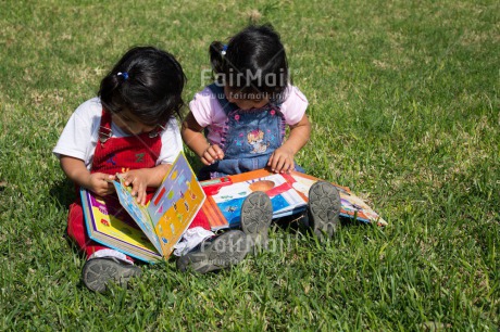 Fair Trade Photo 0-5 years, Book, Casual clothing, Clothing, Colour image, Cooperation, Cute, Day, Education, Friendship, Grass, Latin, Outdoor, People, Peru, Reading, School, Sister, South America, Together, Two girls