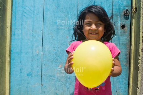 Fair Trade Photo 5 -10 years, Activity, Balloon, Birth, Birthday, Colour image, Horizontal, Latin, Looking at camera, New baby, One girl, People, Peru, Pink, Round, Smiling, South America, Yellow, Zero