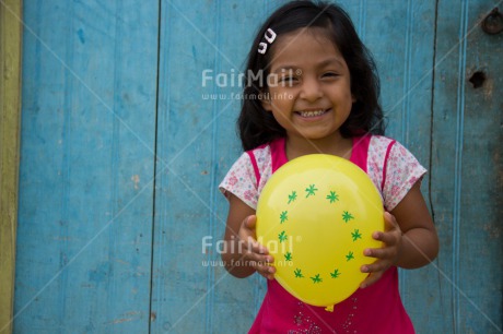 Fair Trade Photo 5 -10 years, Activity, Balloon, Birth, Birthday, Colour image, Horizontal, Latin, Looking at camera, New baby, One girl, People, Peru, Pink, Round, Smiling, South America, Yellow, Zero