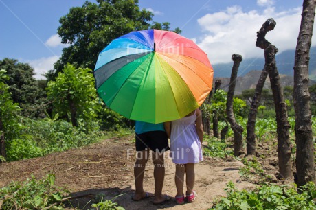 Fair Trade Photo Colour image, Cute, Day, Friendship, Holiday, Horizontal, One boy, One girl, Outdoor, People, Peru, Rural, Scenic, South America, Together, Travel, Two children, Umbrella