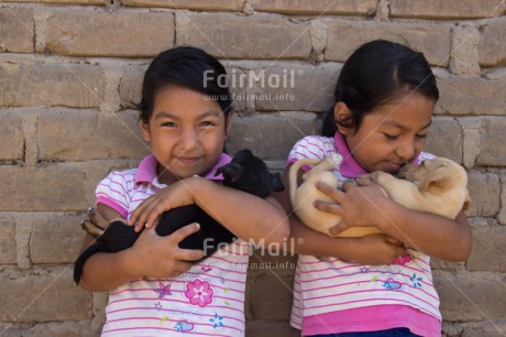 Fair Trade Photo Activity, Animals, Caring, Carrying, Colour image, Cute, Dog, Horizontal, Hugging, Love, People, Peru, Puppy, South America, Twin, Two girls