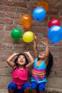 Fair Trade Photo Activity, Balloon, Colour image, Cooperation, Emotions, Friendship, Happiness, People, Peru, Playing, Smiling, South America, Throwing, Twin, Two girls, Vertical