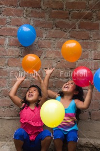 Fair Trade Photo Activity, Balloon, Colour image, Cooperation, Emotions, Friendship, Happiness, People, Peru, Playing, Smiling, South America, Throwing, Twin, Two girls, Vertical
