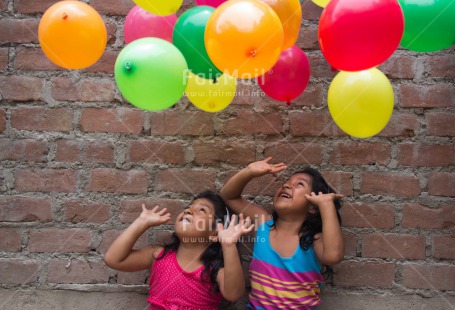 Fair Trade Photo Activity, Balloon, Colour image, Cooperation, Emotions, Friendship, Happiness, Horizontal, People, Peru, Playing, Smiling, South America, Throwing, Twin, Two girls