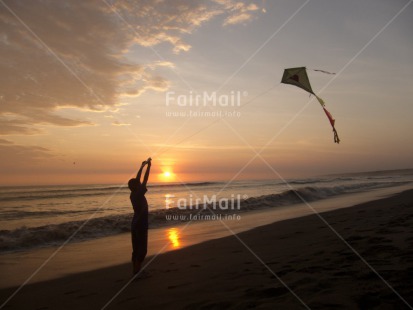 Fair Trade Photo Activity, Backlit, Beach, Colour image, Evening, Freedom, Kite, One boy, Outdoor, People, Peru, Playing, Sea, Silhouette, South America, Summer