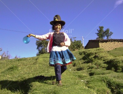Fair Trade Photo Activity, Balloon, Clothing, Colour image, Emotions, Game, Happiness, Horizontal, Multi-coloured, One girl, Outdoor, People, Peru, Playing, Portrait fullbody, Running, Rural, Skirt, Sombrero, South America, Traditional clothing