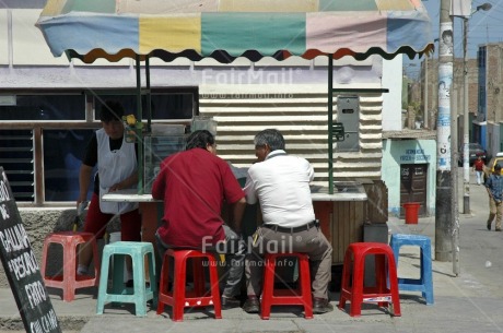 Fair Trade Photo Activity, Casual clothing, Clothing, Colour image, Communication, Dailylife, Day, Eating, Friendship, Horizontal, Outdoor, People, Peru, Sitting, South America, Street, Streetlife, Together, Two men