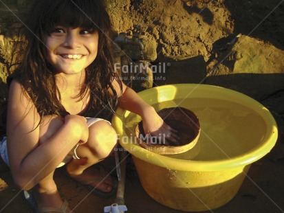 Fair Trade Photo 5-10 years, Activity, Colour image, Horizontal, Hygiene, Latin, Looking at camera, One girl, People, Peru, Portrait fullbody, Sanitation, Sitting, Smile, Smiling, South America, Water