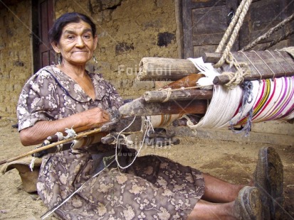 Fair Trade Photo Activity, Casual clothing, Clothing, Colour image, Crafts, Day, Entrepreneurship, Horizontal, House, Looking at camera, One woman, Outdoor, People, Peru, Portrait fullbody, Rural, Sitting, South America, Weaving, Working