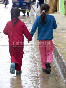 Fair Trade Photo Activity, Blue, Casual clothing, Clothing, Colour image, Cooperation, Dailylife, Day, Friendship, Outdoor, People, Peru, Red, South America, Street, Streetlife, Together, Two children, Two girls, Vertical, Walking