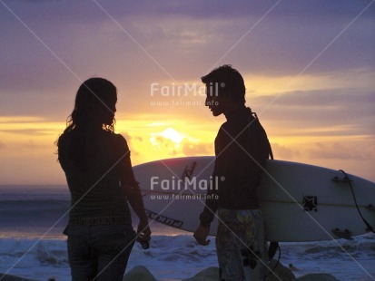Fair Trade Photo Colour image, Evening, Horizontal, Love, One boy, One girl, Outdoor, People, Peru, Sea, Sky, South America, Sport, Sunset, Surfboard, Travel, Water