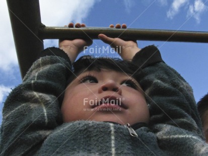 Fair Trade Photo 5 -10 years, Activity, Balance, Closeup, Colour image, Cute, Horizontal, Latin, Looking away, Low angle view, One boy, People, Peru, Playground, Playing, Portrait halfbody, Sky, South America, Strength, Well done