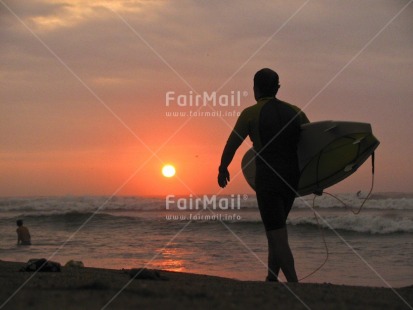 Fair Trade Photo Activity, Backlit, Beach, Colour image, Horizontal, One man, People, Peru, Scenic, Sea, Silhouette, South America, Sport, Sun, Sunset, Surfboard, Surfer, Travel, Walking, Water