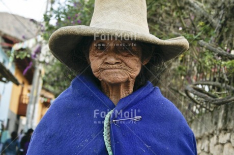 Fair Trade Photo 70-75 years, Activity, Blue, Clothing, Colour image, Dailylife, Day, Grandmother, Hat, Horizontal, Latin, Looking at camera, Old age, One woman, Outdoor, People, Peru, Rural, Sombrero, South America, Street, Streetlife, Traditional clothing